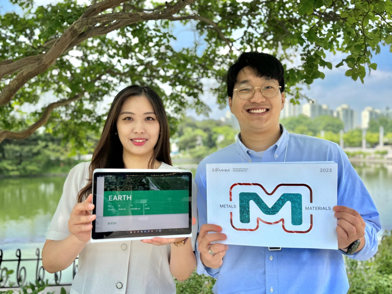 LS MnM 신입사원들이 새로 발간한 지속가능경영보고서를 선보이고 있다.