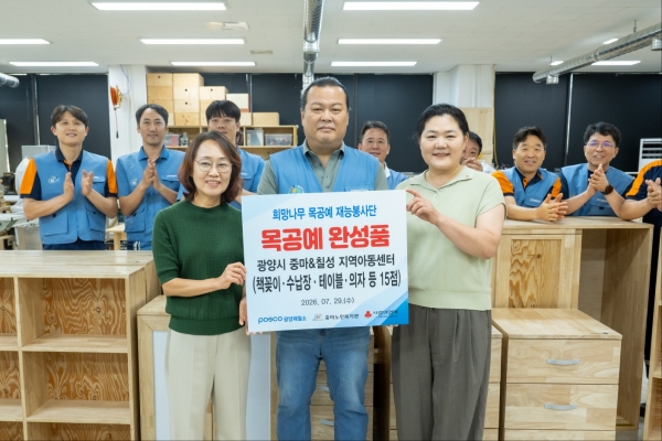 광양제철소 희망나무 목공예 재능봉사단이 직접 제작한 목공예 제품을 지역 어린이들을 위해 전달한 뒤 기념촬영을 하고 있다. 포스코